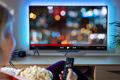 photo of a person watching YouTube on a TV screen