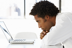 attention-metrics photo of a man looking at a laptop screen