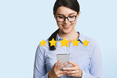 photo of a woman using a smartphone with a 5-star experience rating
