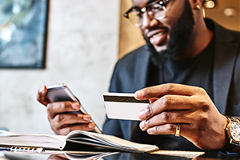 photo of a man conducting a transaction on his smartphone