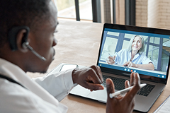 photo of a doctor holding a virtual patient visit on a laptop