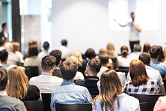 photo of an audience watching a speaker