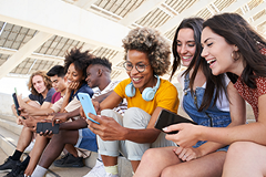photo of a group of young adults with smartphones