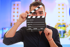 photo of a man holding a clapperboard