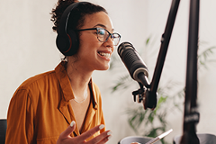 photo of a woman speaking into a microphone