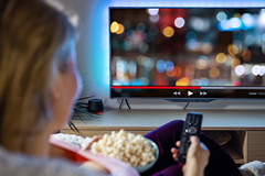 photo of a woman watching TV