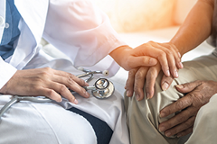 photo of a doctor comforting a patient