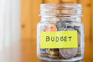 budget photo of coins in a glass jar labeled