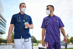 photo of 2 healthcare providers wearing face masks