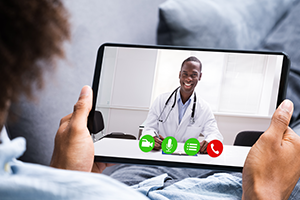 telemedicine picture of a telemedicine session with a doctor on the tablet screen