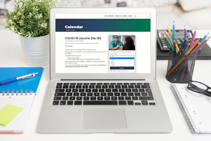 photo of a COVID-19 vaccine website on a laptop computer