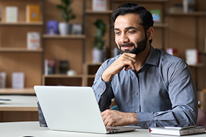 organic-search photo of a young man looking at a laptop